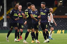 Fabian Schar of Newcastle United celebrates with team mates Dwight Gayle, Joe Willock and Jacob Murphy after scoring his team's second goal during the Premier League match between Fulham and Newcastle United at Craven Cottage on May 23, 2021 in London, England.