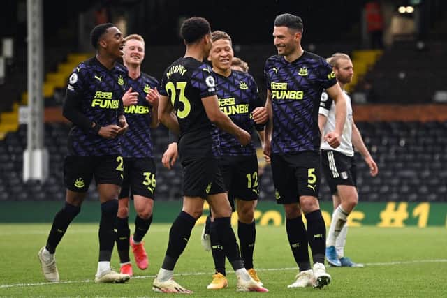 Fabian Schar of Newcastle United celebrates with team mates Dwight Gayle, Joe Willock and Jacob Murphy after scoring his team's second goal during the Premier League match between Fulham and Newcastle United at Craven Cottage on May 23, 2021 in London, England.