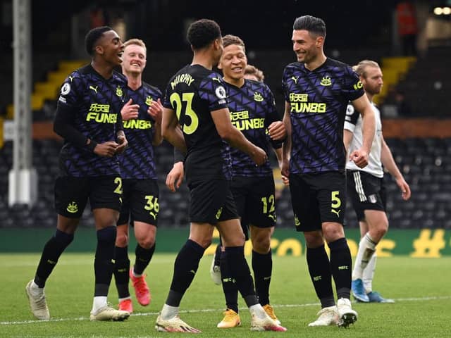 Fabian Schar of Newcastle United celebrates with team mates Dwight Gayle, Joe Willock and Jacob Murphy after scoring his team's second goal during the Premier League match between Fulham and Newcastle United at Craven Cottage on May 23, 2021 in London, England.