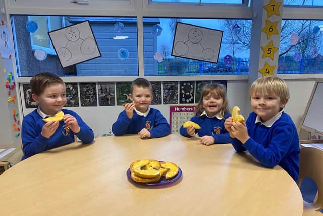 Fellgate Primary pupils, from left, Robert, Evan, Daisy and Samuel tuck into bagels for breakfast. Picture by Helen Towers.