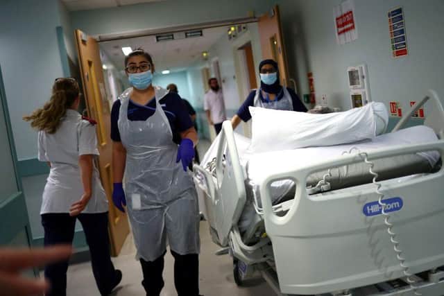 Medical staff transfer a patient along a corridor at the Royal Blackburn Teaching Hospital (Photo: HANNAH MCKAY/POOL/AFP via Getty Images)