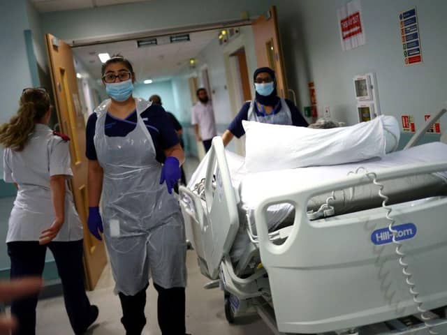 Medical staff transfer a patient along a corridor at the Royal Blackburn Teaching Hospital (Photo: HANNAH MCKAY/POOL/AFP via Getty Images)