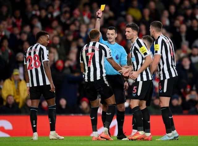 Referee Andy Madley shows a yellow card to Joelinton of Newcastle United during the Premier League match between Arsenal FC and Newcastle United at Emirates Stadium on January 03, 2023 in London, England. (Photo by Justin Setterfield/Getty Images)