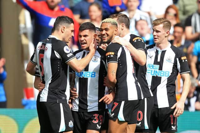 Newcastle United's Brazilian midfielder Bruno Guimaraes (2nd L) celebrates with teammates after scoring their first goal after a VAR (Video Assistant Referee) review during the English Premier League football match between Newcastle United and Leicester City at St James' Park in Newcastle-upon-Tyne, north east England on April 17, 2022. (Photo by LINDSEY PARNABY/AFP via Getty Images)