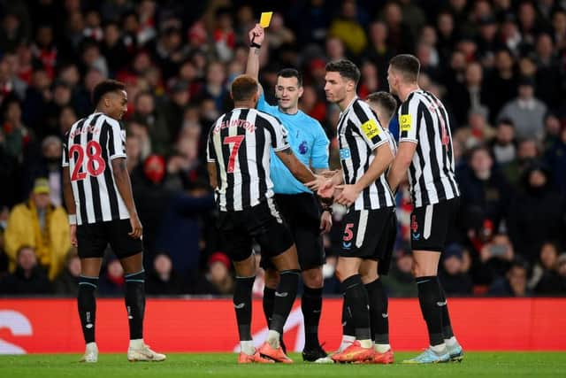 Referee Andy Madley shows a yellow card to Joelinton of Newcastle United during the Premier League match between Arsenal FC and Newcastle United at Emirates Stadium on January 03, 2023 in London, England. (Photo by Justin Setterfield/Getty Images)