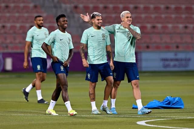 Brazil's forward Vinicius Junior (2nd L), Brazil's midfielder Bruno Guimaraes (C) and Brazil's forward Pedro (R) take part in a training session at Al Arabi SC stadium in Doha on November 23, 2022, on the eve of the Qatar 2022 World Cup football match between Brazil and Serbia. (Photo by NELSON ALMEIDA/AFP via Getty Images)