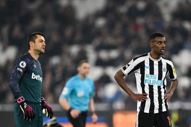 Newcastle United striker Alexander Isak, flanked by West Ham United goalkeeper Lukasz Fabianski, watches as his shot finds the net on Wednesday night.