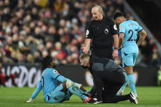 Allan Saint-Maximin gets treatment at Anfield.