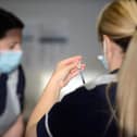 A health worker prepares a dose of covid vaccine.