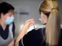 A health worker prepares a dose of covid vaccine.