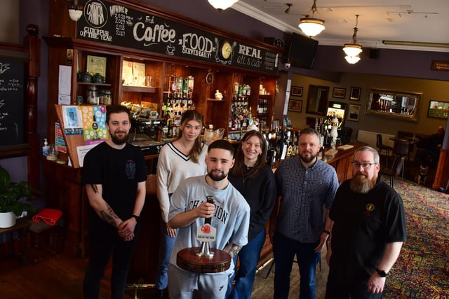Who's for a pint at The Marine? Pub staff pictured with a CAMRA award earlier this year.