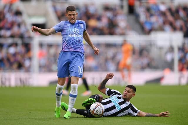 Ryan Christie of AFC Bournemouth is challenged by Bruno Guimaraes of Newcastle United during the Premier League match between Newcastle United and AFC Bournemouth at St. James Park on September 17, 2022 in Newcastle upon Tyne, England. (Photo by Stu Forster/Getty Images)