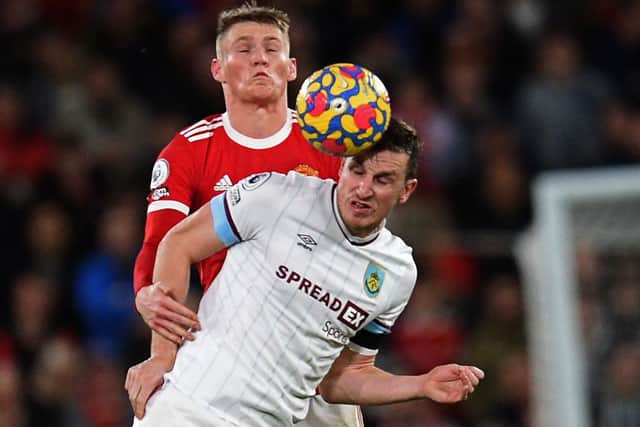 Manchester United's Scottish midfielder Scott McTominay (L) vies with Burnley's New Zealand striker Chris Wood (R) during the English Premier League football match between Manchester United and Burnley at Old Trafford in Manchester, north-west England, on December 30, 2021 (Photo by OLI SCARFF/AFP via Getty Images)