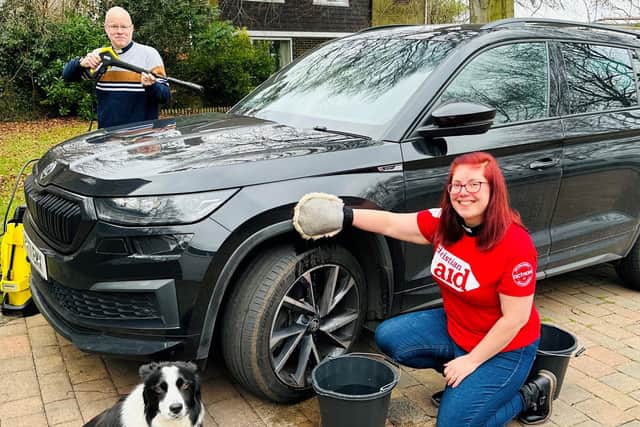 Revs Emma and Paul Barker with Maisie the dog are getting ready for Christian Aid Week.