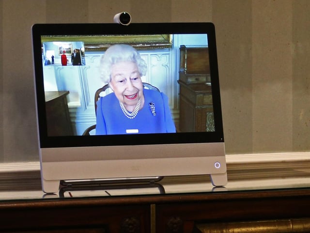 Queen Elizabeth II appearing on a screen by videolink from Windsor Castle, where she is in residence, during a virtual audience to receive His Excellency the Ambassador of Germany Andreas Michaelis and his wife Heike Michaelis, who were at London's Buckingham Palace. 10/12/20