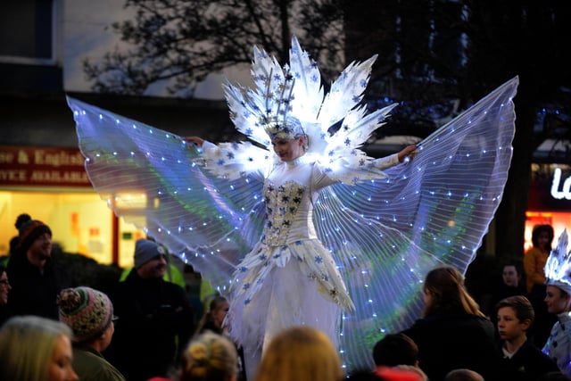 A stilt walker entertains the crowd