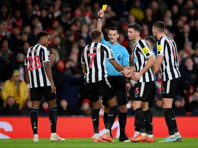 Referee Andy Madley shows a yellow card to Joelinton of Newcastle United during the Premier League match between Arsenal FC and Newcastle United at Emirates Stadium on January 03, 2023 in London, England. (Photo by Justin Setterfield/Getty Images)