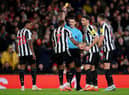 Referee Andy Madley shows a yellow card to Joelinton of Newcastle United during the Premier League match between Arsenal FC and Newcastle United at Emirates Stadium on January 03, 2023 in London, England. (Photo by Justin Setterfield/Getty Images)