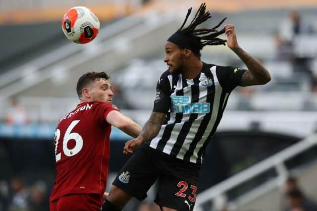 Newcastle United's Austrian midfielder Valentino Lazaro (R) heads the ball next to Liverpool's Scottish defender Andrew Robertson during the English Premier League football match between Newcastle United and Liverpool at St James' Park in Newcastle-upon-Tyne, north east England on July 26, 2020.