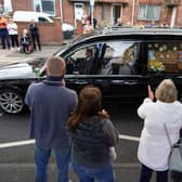 Well wishers line the streets of Ashington in Northumberland to pay their respects as the funeral cortege for Jack Charlton passes through his childhood home town.