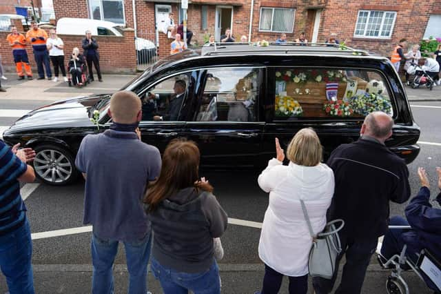 Well wishers line the streets of Ashington in Northumberland to pay their respects as the funeral cortege for Jack Charlton passes through his childhood home town.