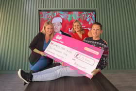 Emma Chesterton, Sales Director for Bellway North East, hands over the sponsorship cheque