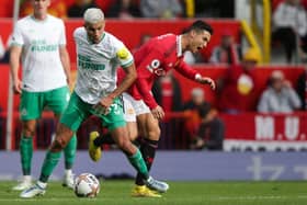 Newcastle United's Brazilian midfielder Bruno Guimaraes (L) fights for the ball with Manchester United's Portuguese striker Cristiano Ronaldo during the English Premier League football match between Manchester United and Newcastle at Old Trafford in Manchester, north west England, on October 16, 2022.  (Photo by IAN HODGSON/AFP via Getty Images)