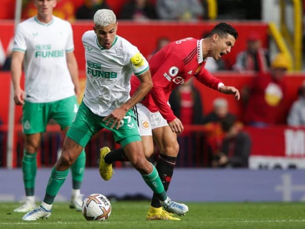 Newcastle United's Brazilian midfielder Bruno Guimaraes (L) fights for the ball with Manchester United's Portuguese striker Cristiano Ronaldo during the English Premier League football match between Manchester United and Newcastle at Old Trafford in Manchester, north west England, on October 16, 2022.  (Photo by IAN HODGSON/AFP via Getty Images)