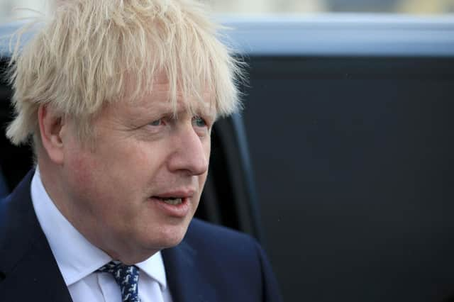 Boris Johnson reacts as he greets members of the public while campaigning on behalf of Conservative Party candidate Jill Mortimer (unseen) ahead of the 2021 Hartlepool by-election to be held on May 6 on May 3, 2021 in Hartlepool, north-east England. (Photo by Lindsey Parnaby - WPA Pool/Getty Images)