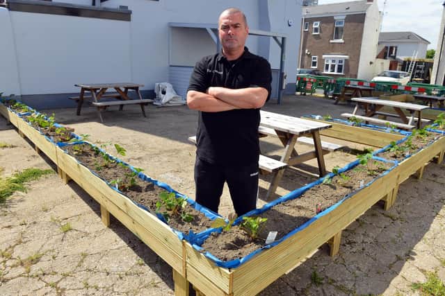 The Look Out landlord Michael Ward with the garden planters that have been placed in the car park beside his pub.