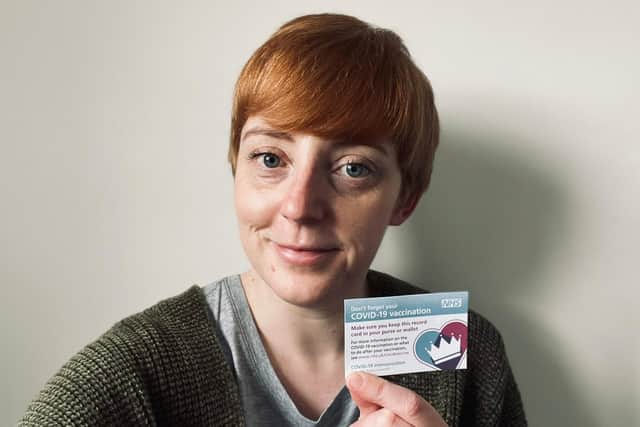 Debra with her Covid vaccine appointment card.