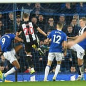 Newcastle United's French midfielder Florian Lejeune (C) scores their second late goal in a goalmouth scramble to equalise 2-2 during the English Premier League football match between Everton and Newcastle United at Goodison Park in Liverpool, north west England on January 21, 2020.