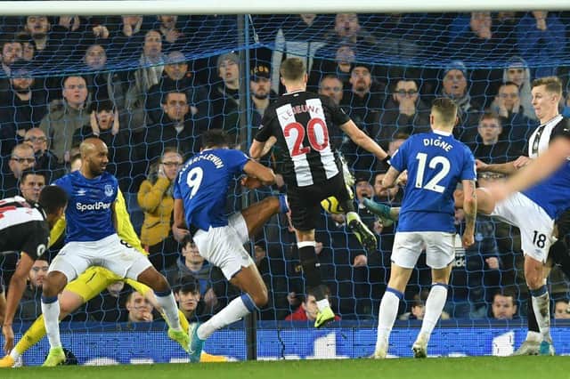 Newcastle United's French midfielder Florian Lejeune (C) scores their second late goal in a goalmouth scramble to equalise 2-2 during the English Premier League football match between Everton and Newcastle United at Goodison Park in Liverpool, north west England on January 21, 2020.