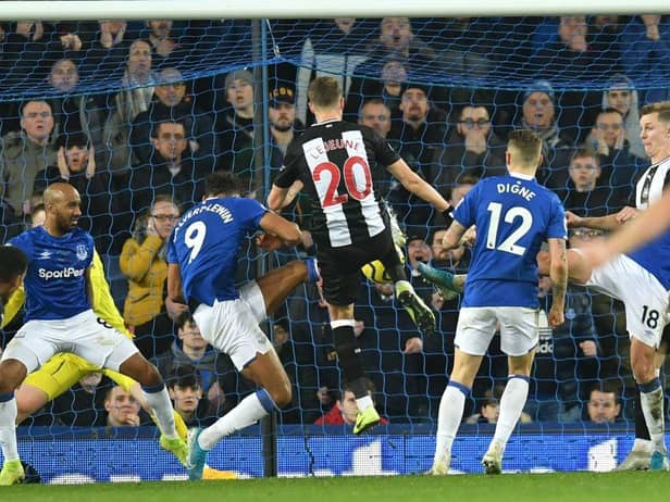 Newcastle United's French midfielder Florian Lejeune (C) scores their second late goal in a goalmouth scramble to equalise 2-2 during the English Premier League football match between Everton and Newcastle United at Goodison Park in Liverpool, north west England on January 21, 2020.