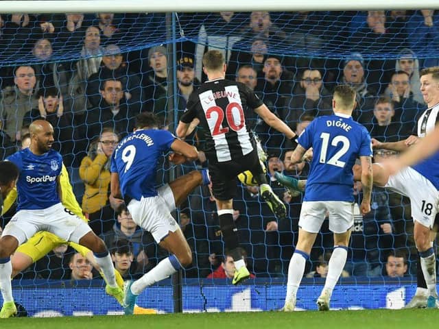 Newcastle United's French midfielder Florian Lejeune (C) scores their second late goal in a goalmouth scramble to equalise 2-2 during the English Premier League football match between Everton and Newcastle United at Goodison Park in Liverpool, north west England on January 21, 2020.