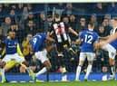 Newcastle United's French midfielder Florian Lejeune (C) scores their second late goal in a goalmouth scramble to equalise 2-2 during the English Premier League football match between Everton and Newcastle United at Goodison Park in Liverpool, north west England on January 21, 2020.