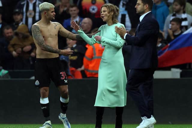Newcastle player Bruno Guimaraes shares a joke with co-owner Amanda Staveley on the pitch after the Premier League match between Newcastle United and Arsenal at St. James Park on May 16, 2022 in Newcastle upon Tyne, England. (Photo by Ian MacNicol/Getty Images)