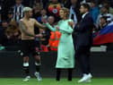 Newcastle player Bruno Guimaraes shares a joke with co-owner Amanda Staveley on the pitch after the Premier League match between Newcastle United and Arsenal at St. James Park on May 16, 2022 in Newcastle upon Tyne, England. (Photo by Ian MacNicol/Getty Images)