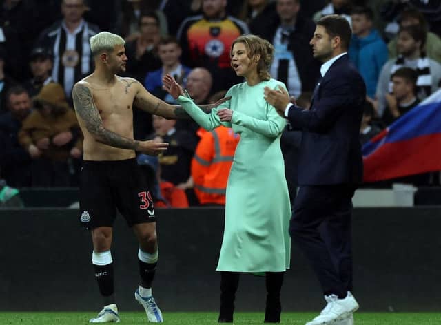 Newcastle player Bruno Guimaraes shares a joke with co-owner Amanda Staveley on the pitch after the Premier League match between Newcastle United and Arsenal at St. James Park on May 16, 2022 in Newcastle upon Tyne, England. (Photo by Ian MacNicol/Getty Images)