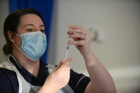 A health professional prepares to administer the covid vaccine.