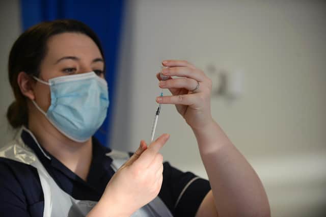 A health professional prepares to administer the covid vaccine.