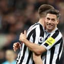 Newcastle United's Fabian Schar embraces team-mate Sean Longstaff after the Wolverhampton Wanderers win last weekend.