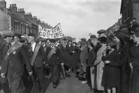 The Jarrow March passes through a town in the North East in October 1936 on their way to Parliament to hand in a petition and protest the mass unemployment. Photo by Central Press/Hulton Archive/Getty Images