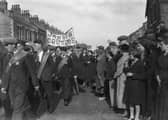 The Jarrow March passes through a town in the North East in October 1936 on their way to Parliament to hand in a petition and protest the mass unemployment. Photo by Central Press/Hulton Archive/Getty Images