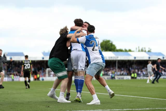 Bristol Rovers fans swarm Anthony Evans following his side's seventh goal during the Sky Bet League Two match at the Memorial Stadium, Bristol. Picture date: Saturday May 7, 2022.