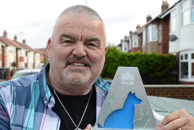 Tony Carlisle with his Fundraiser of the Year trophy from the 2019 Animal Heroes Awards.