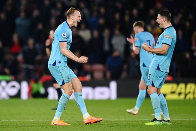 Dan Burn and Fabian Schar of Newcastle United celebrate after the final whistle of the match during the Premier League match between Southampton and Newcastle United at St Mary's Stadium on March 10, 2022 in Southampton, England. (Photo by Dan Mullan/Getty Images)