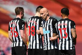 Sean Longstaff, Federico Fernandez, Jonjo Shelvey and Callum Wilson of Newcastle United line up in the wall for a free kick during the Premier League match between Liverpool and Newcastle United at Anfield on April 24, 2021 in Liverpool, England.