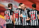 Sean Longstaff, Federico Fernandez, Jonjo Shelvey and Callum Wilson of Newcastle United line up in the wall for a free kick during the Premier League match between Liverpool and Newcastle United at Anfield on April 24, 2021 in Liverpool, England.