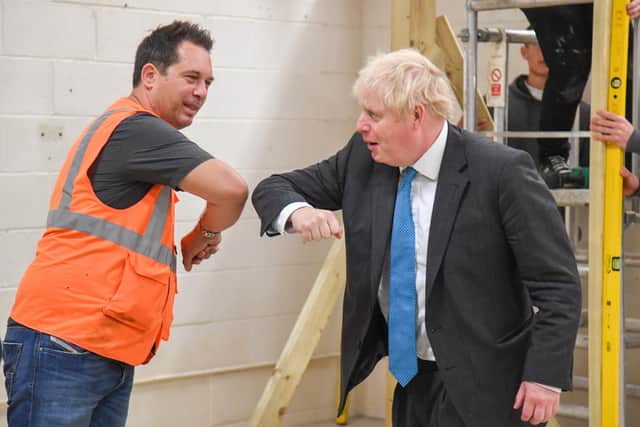 Prime Minister Boris Johnson meets students during a visit to Exeter College earlier today - he was also asked about the new rule for the North East, banning households from mixing in "any setting" but confusion remains. Photo by PA.